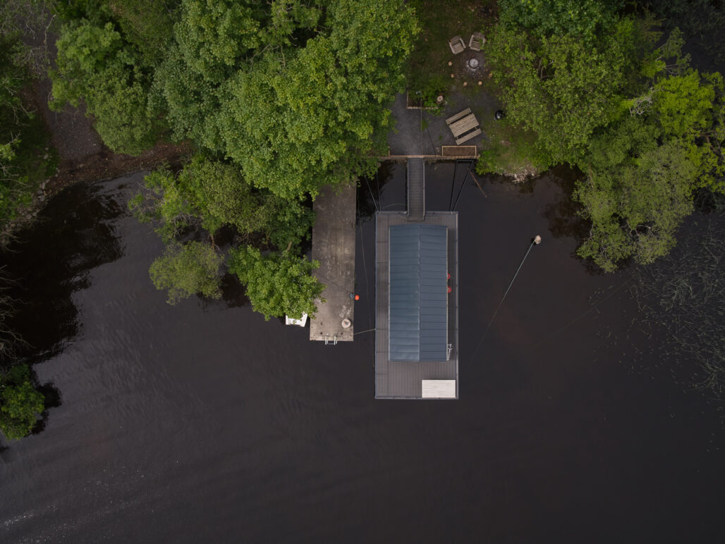 Aerial view of C250 houseboat on a lake in Fermanagh with pontoon and boat